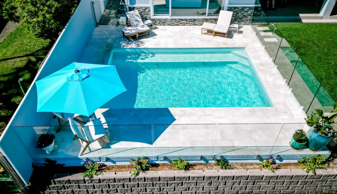 Family pool next to house in small backyard on Gold Coast