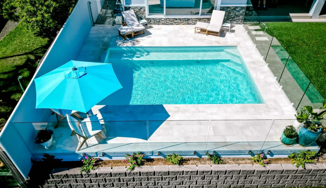 Family pool next to house in small backyard on Gold Coast
