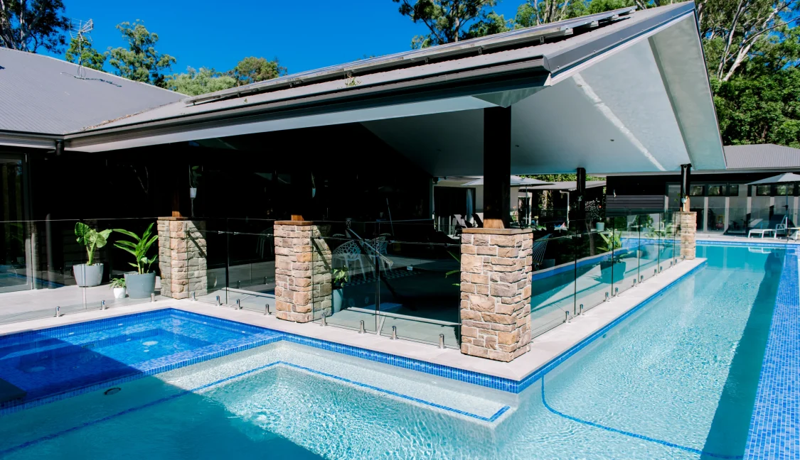 Cool family pool design wrapping around home on Gold Coast